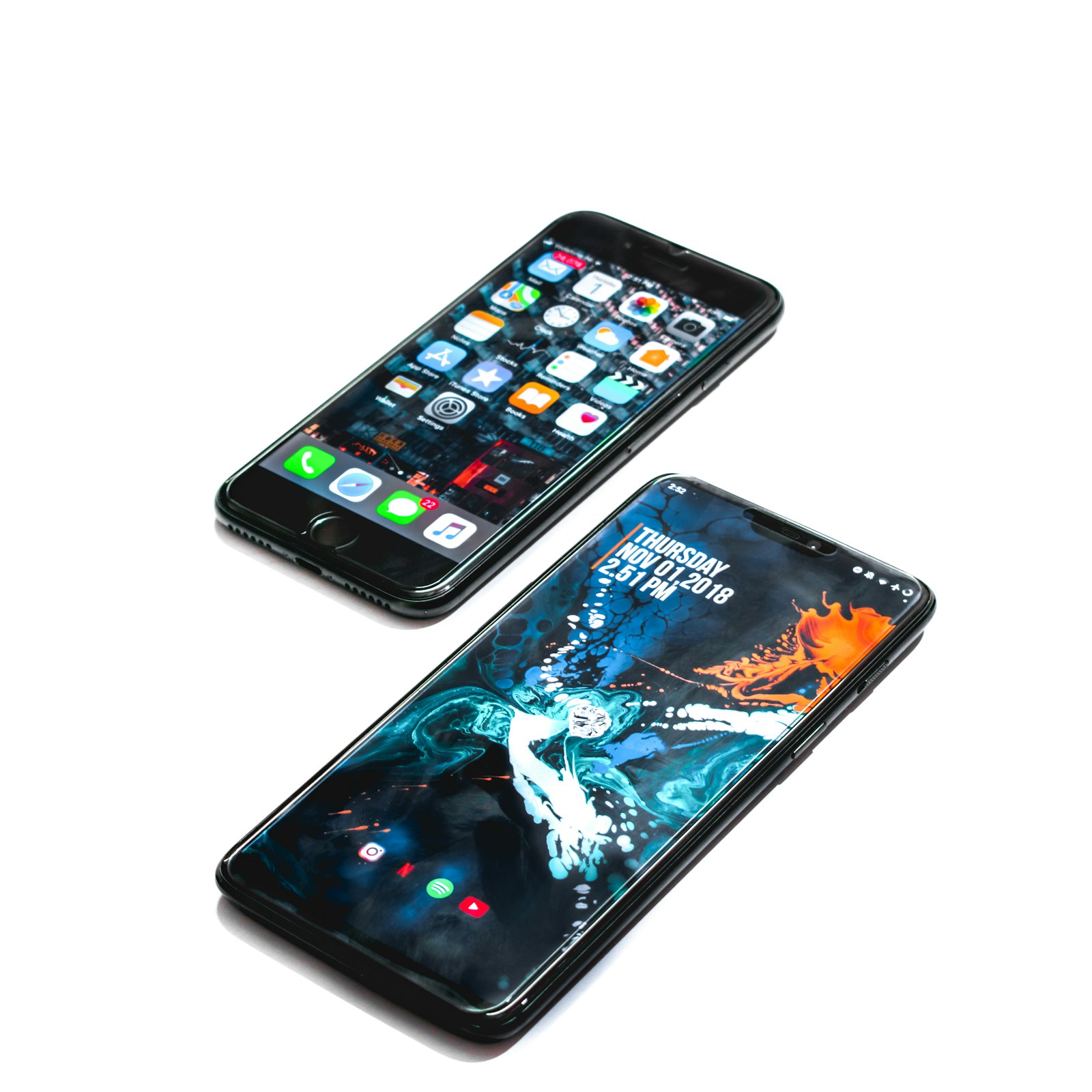 Modern smartphone held in one hand against a plain background